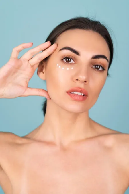 close up beauty portrait topless woman with perfect skin natural make up with anti aging cream dots moisturize firm skin eyes 1