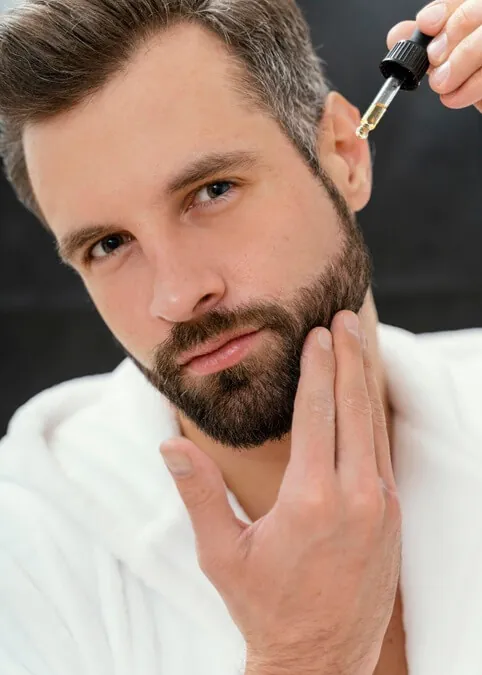 man using natural oils his face 1