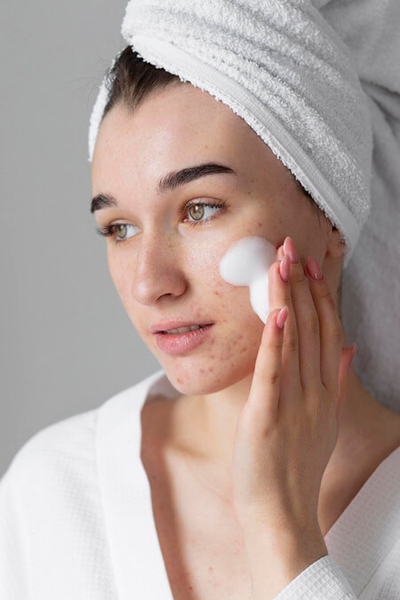 woman usign skincare porduct 1